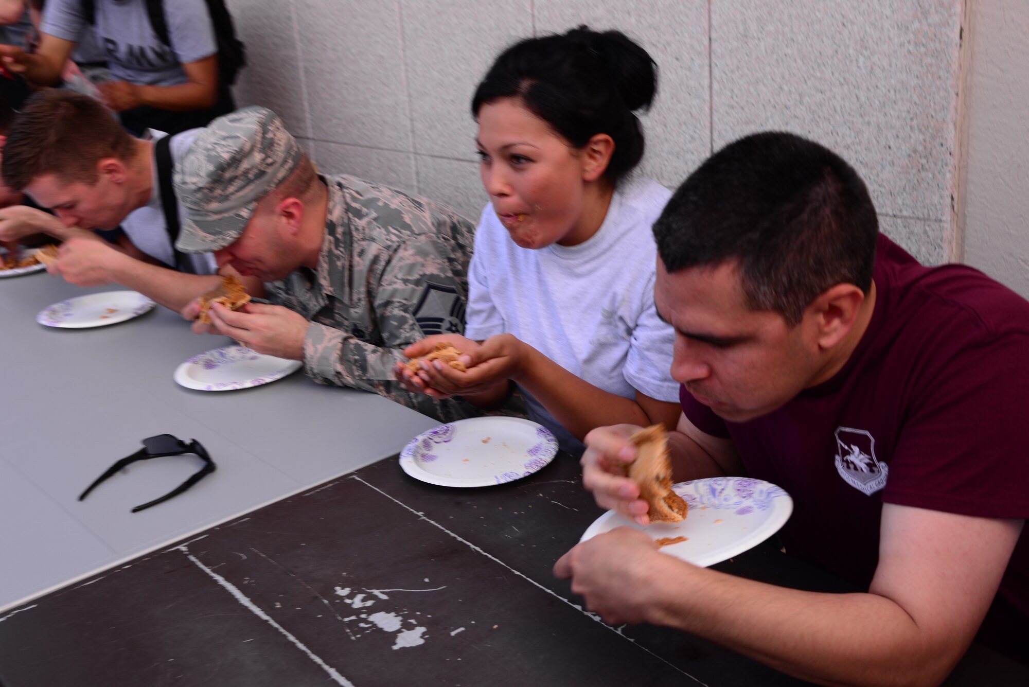 Contestants eat pumpkin pie in the first round of the pie eating contest starting the Osan Cup Sept. 29, 2015, at Osan Air Base, Republic of Korea. The Osan Cup  readiness, teamwork and fun, while building relationships across Team Osan readiness, teamwork and fun, while building relationships across Team Osan had many activities designed to strengthen readiness and teamwork while having fun. (U.S. Air Force photo by Staff Sgt. Benjamin Sutton) 