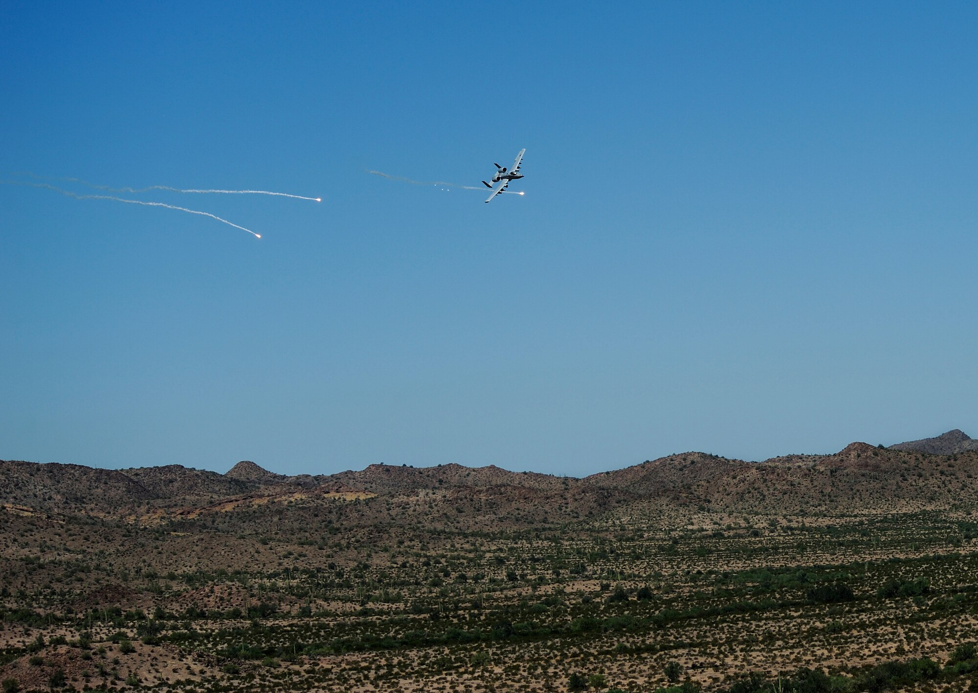 A U.S. Air Force A-10C Thunderbolt II assigned to the 357th Fighter Squadron executes defensive maneuvering in correspondence with British Armed Forces joint tactical air controllers at Barry M. Goldwater Range, Ariz., Sept. 23, 2015. JTACs relay information to pilots such as target location, threat type and ordnance delivery to eliminate enemy forces. (U.S. Air Force photo by Airman 1st Class Chris Drzazgowski/Released)