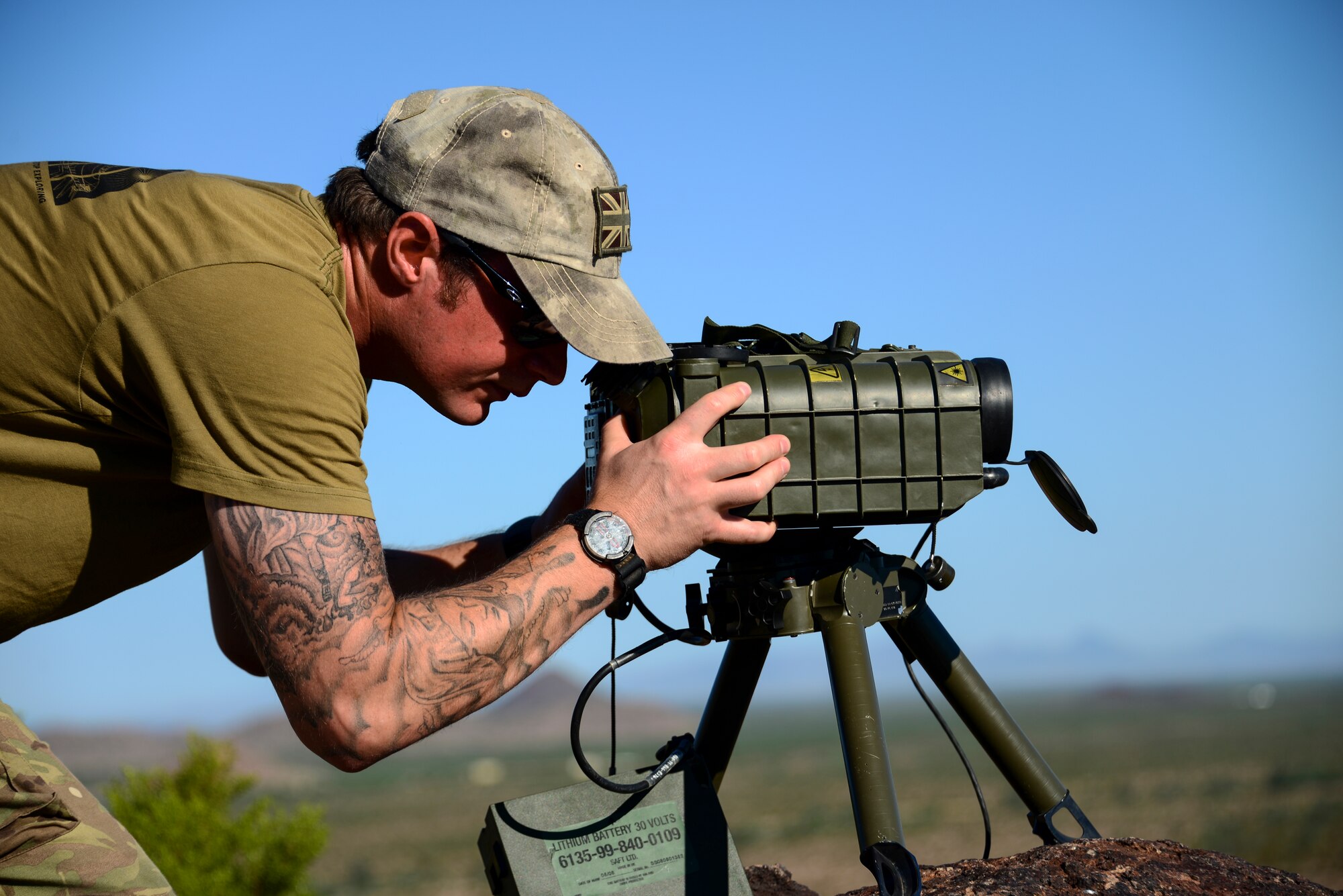 Royal Air Force Cpl. Paul Marshall, RAF Regiment joint tactical air controller, uses a laser targeting system to mark a preemptive target at Barry M. Goldwater Range, Ariz., Sept. 23, 2015. The targeting system provides an indicator for fighter pilots to eliminate enemy forces with precision. (U.S. Air Force photo by Airman 1st Class Chris Drzazgowski/Released)