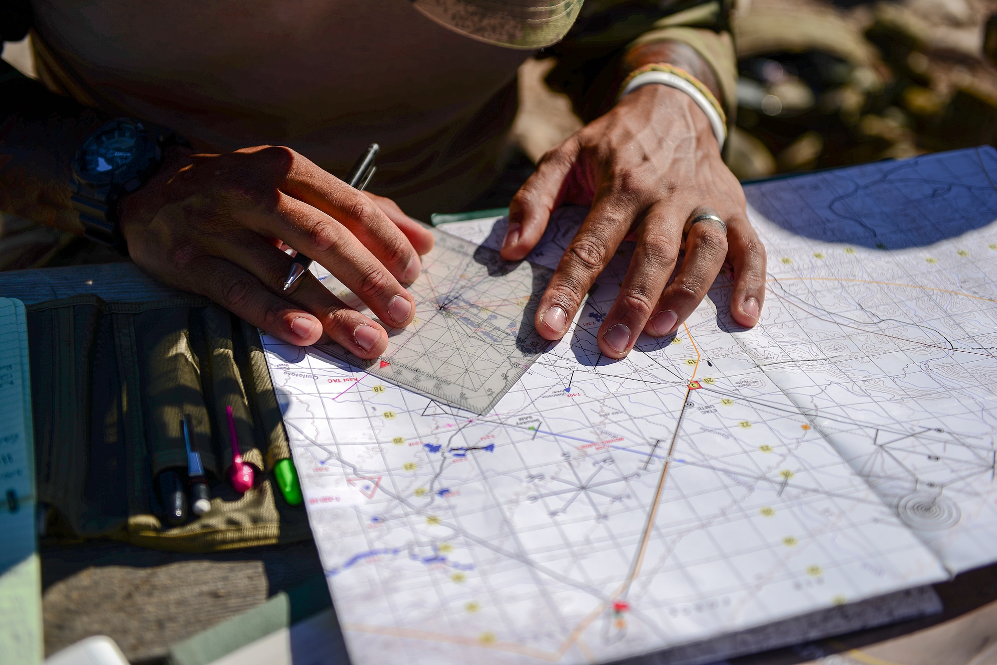 British Army Sgt. Daniel Campbell, Royal Lancers joint tactical air controller, uses a protractor, map and navigation skills to plan preemptive targets at Barry M. Goldwater Range, Ariz., Sept. 23, 2015. The British Armed Forces JTACs are the link between air and ground communications and are charged with ensuring that they can direct any ordnance that leaves an aircraft while protecting civilians and friendly troops at all times. (U.S. Air Force photo by Airman 1st Class Chris Drzazgowski/Released)