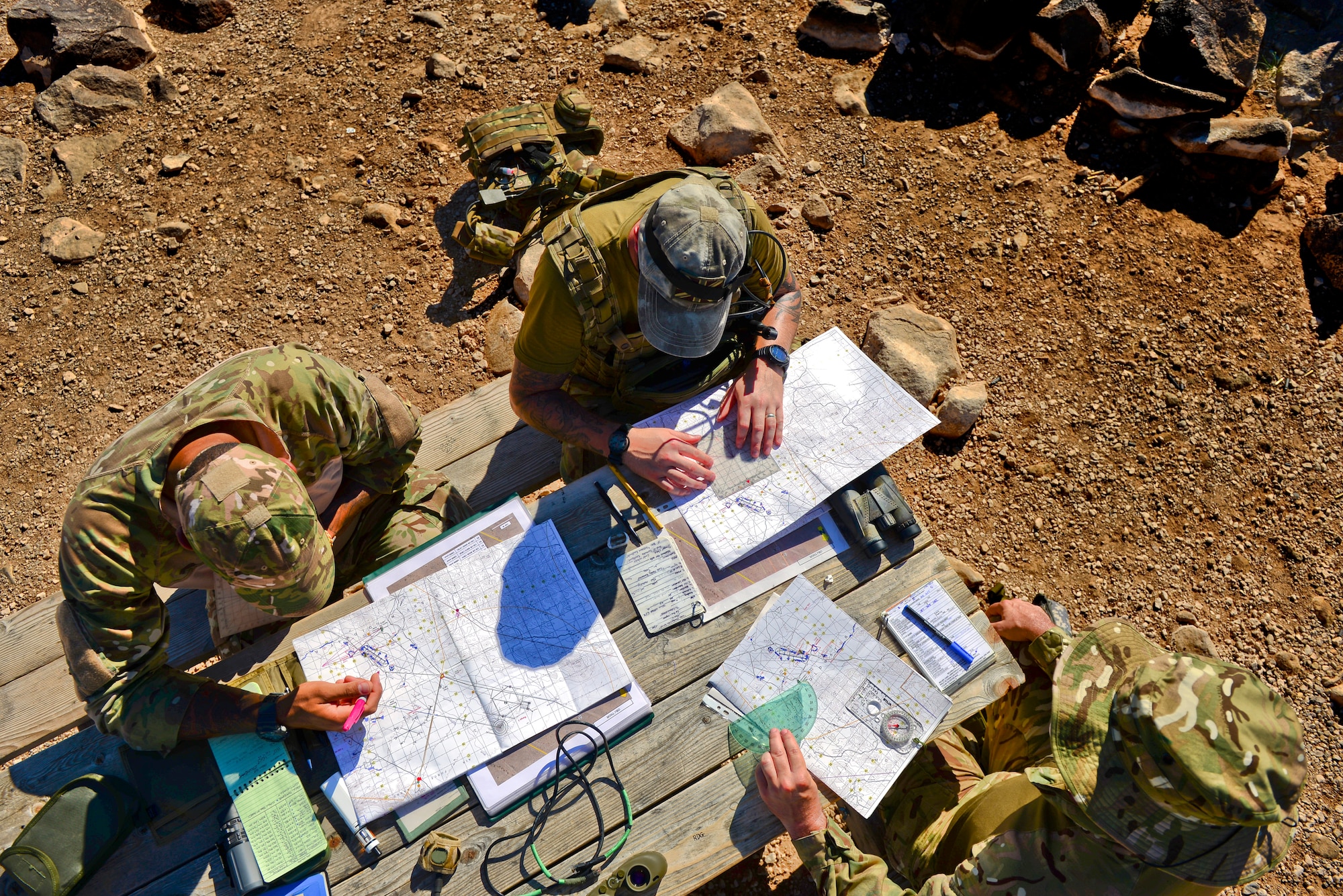 British Armed Forces joint tactical air controllers administer navigation skills using trigonometry and maps at Barry M. Goldwater Range, Ariz., Sept. 23, 2015. The JTACs utilized BMGR because of its abundance of air traffic which provides more opportunities to practice tactical air control. (U.S. Air Force photo by Airman 1st Class Chris Drzazgowski/Released)