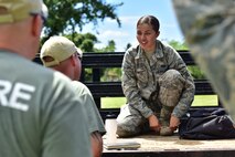 Airman Kenya Ortiz, 647th Security Forces Squadron entry controller, listens to an overview of her performance during Air Force Fly-Away Security Team training, or FAST, Sept. 25, 2015, at Joint Base Pearl Harbor-Hickam. FAST provides forward-deploying Airmen the opportunity to enhance specific skills in the areas of security, mission planning, threat assessments, and combatives. The training intertwines various skill sets and teaches selectees how to be security police, ambassadors, and humanitarians at the same time. (U.S. Air Force photo by Staff Sgt. Christopher Stoltz/Released)