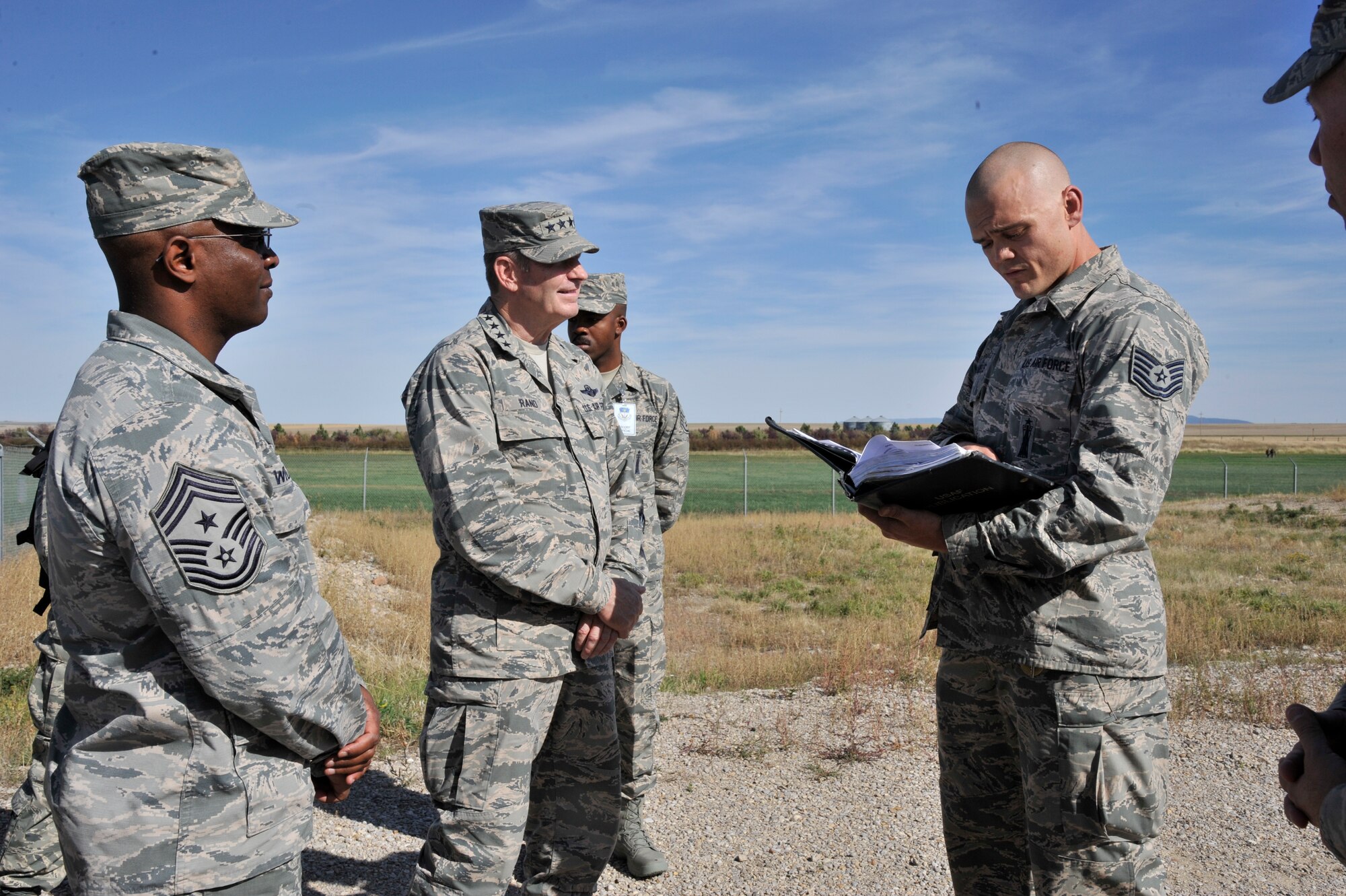 Tech. Sgt. Christopher Daniels, a 341st Missile Maintenance Squadron team chief, provides a safety brief to Gen. Robin Rand, AFGSC commander, and Chief Master Sgt. Calvin Williams, incoming AFGSC command chief, before touring a launch facility in the Malmstrom Air Force Base, Mont. missile field, Sept. 25, 2015. Rand visited Team Malmstrom members during a tour of the base, Sept. 24-26. (U.S. Air Force photo/John Turner)