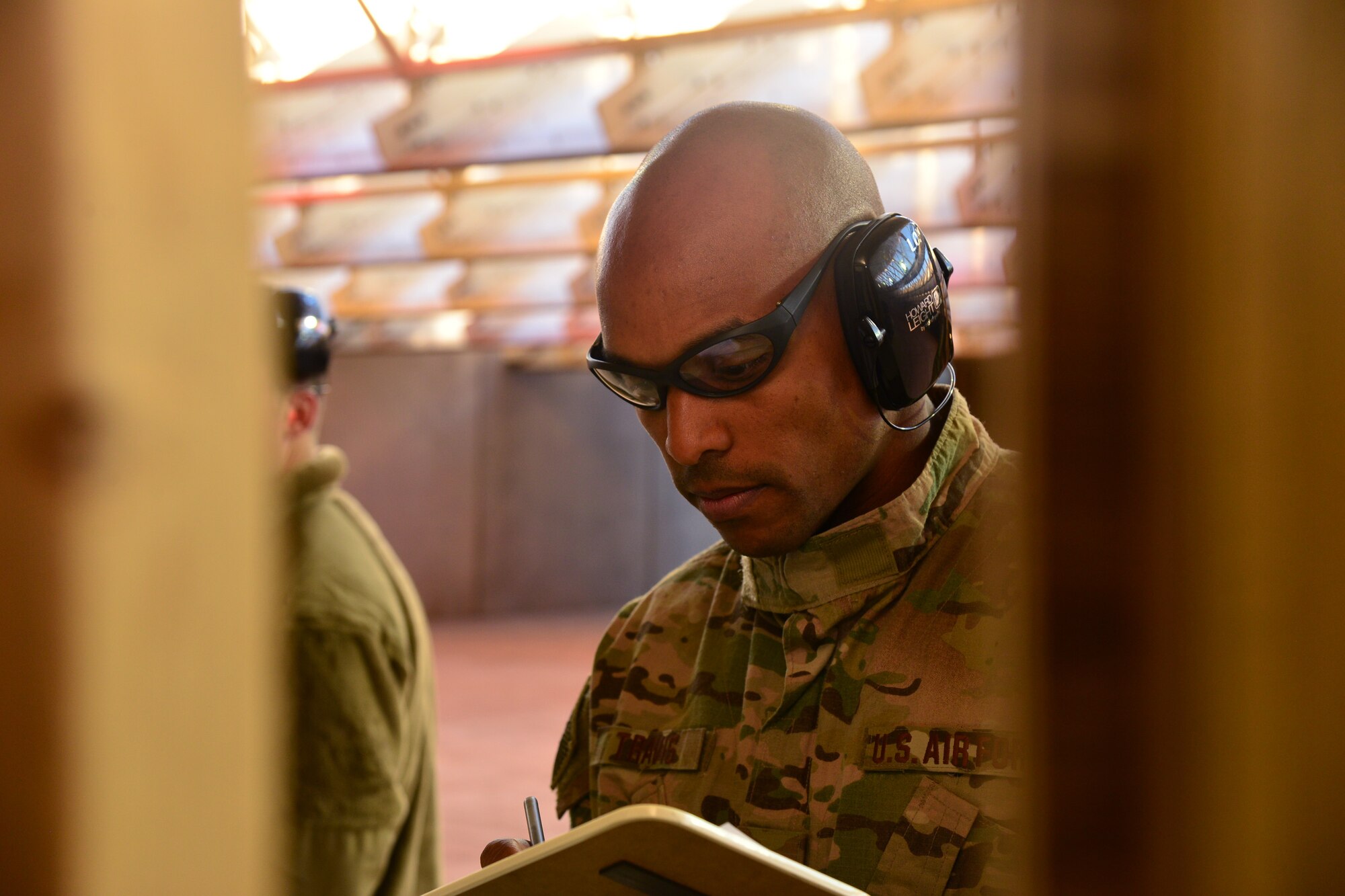 An Airman tallies the score of a shooter at an Excellence in Competition Marksman Event, held at the base firing range Sept. 28-29 at Malmstrom Air Force Base, Mont. At the end of each of three rounds, Airmen checked their neighbor’s target to tally up points.  (U.S. Air Force photo/Airman Daniel Brosam)