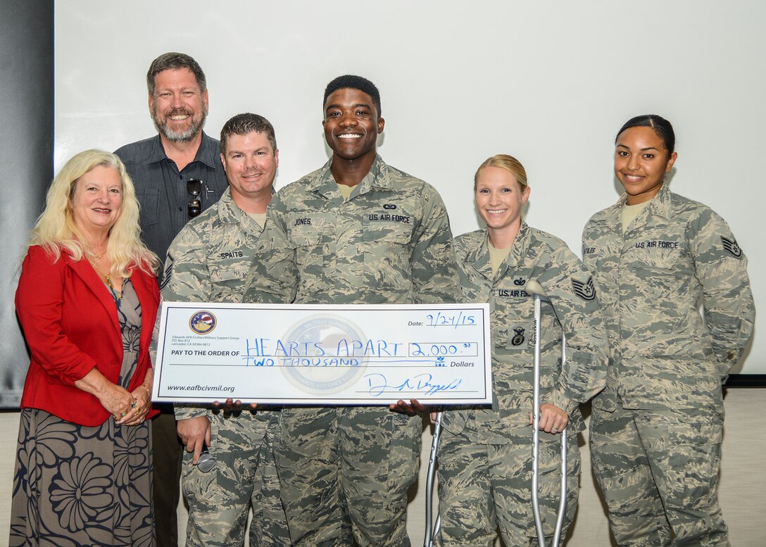 The Friends of the Airman and Family Readiness Center accepted a donation of $2,000 from the Edwards AFB Civilian-Military Support Group during a Hearts Apart luau at the AFRC Sept. 24. (left to right) J.J. Stewart, A&FRC director, Danny A. Bazzell, Civ-Mil community liaison, and members of the Friends of the A&FRC: Master Sgt. Damian Spaits, Senior Airman Ronald Jones, Tech. Sgt. Amanda Esparza and Staff Sgt. Stephanie Artiles. (U.S. Air Force photo by Rebecca Amber)
