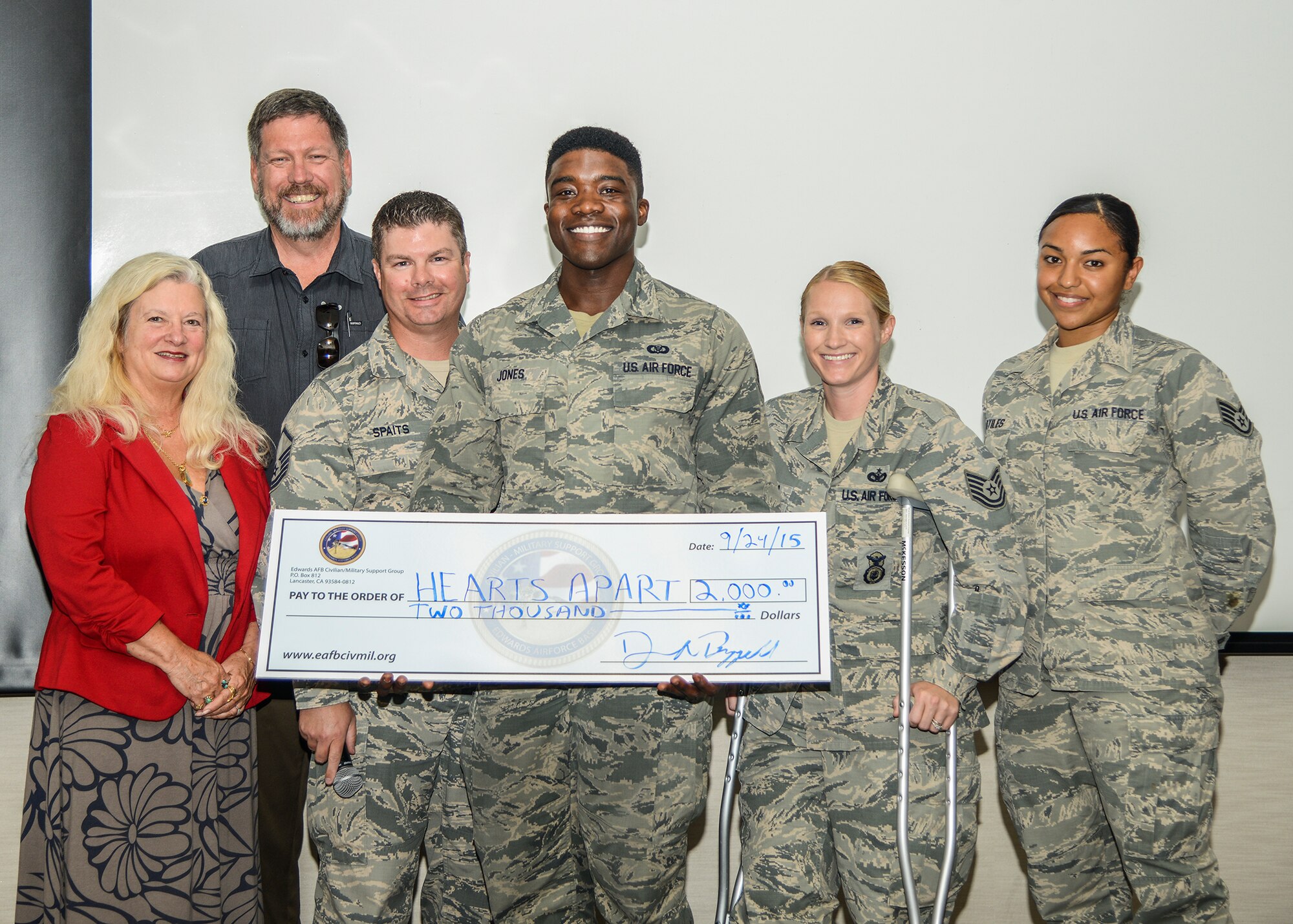 The Friends of the Airman and Family Readiness Center accepted a donation of $2,000 from the Edwards AFB Civilian-Military Support Group during a Hearts Apart luau at the AFRC Sept. 24. (left to right) J.J. Stewart, A&FRC director, Danny A. Bazzell, Civ-Mil community liaison, and members of the Friends of the A&FRC: Master Sgt. Damian Spaits, Senior Airman Ronald Jones, Tech. Sgt. Amanda Esparza and Staff Sgt. Stephanie Artiles. (U.S. Air Force photo by Rebecca Amber)
