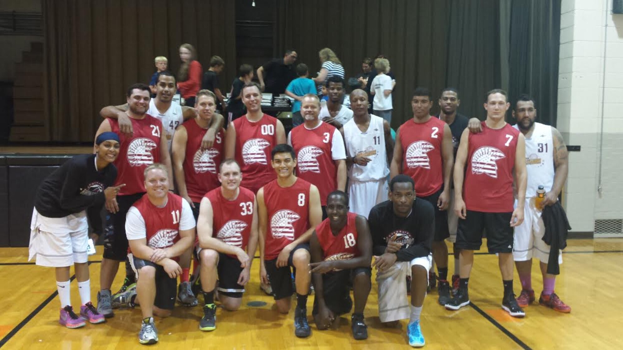 Members of the Cavalier Air Force Station Instigators basketball team pose with members of the Harlem Ambassadors at the Cavalier Public School in Cavalier, N.D., Sept. 28, 2015. The Ambassadors performed their unique style of basketball while delivering a message on anti-bullying during a school assembly. (Courtesy photo by 2nd Lt. Brandy Benesch)