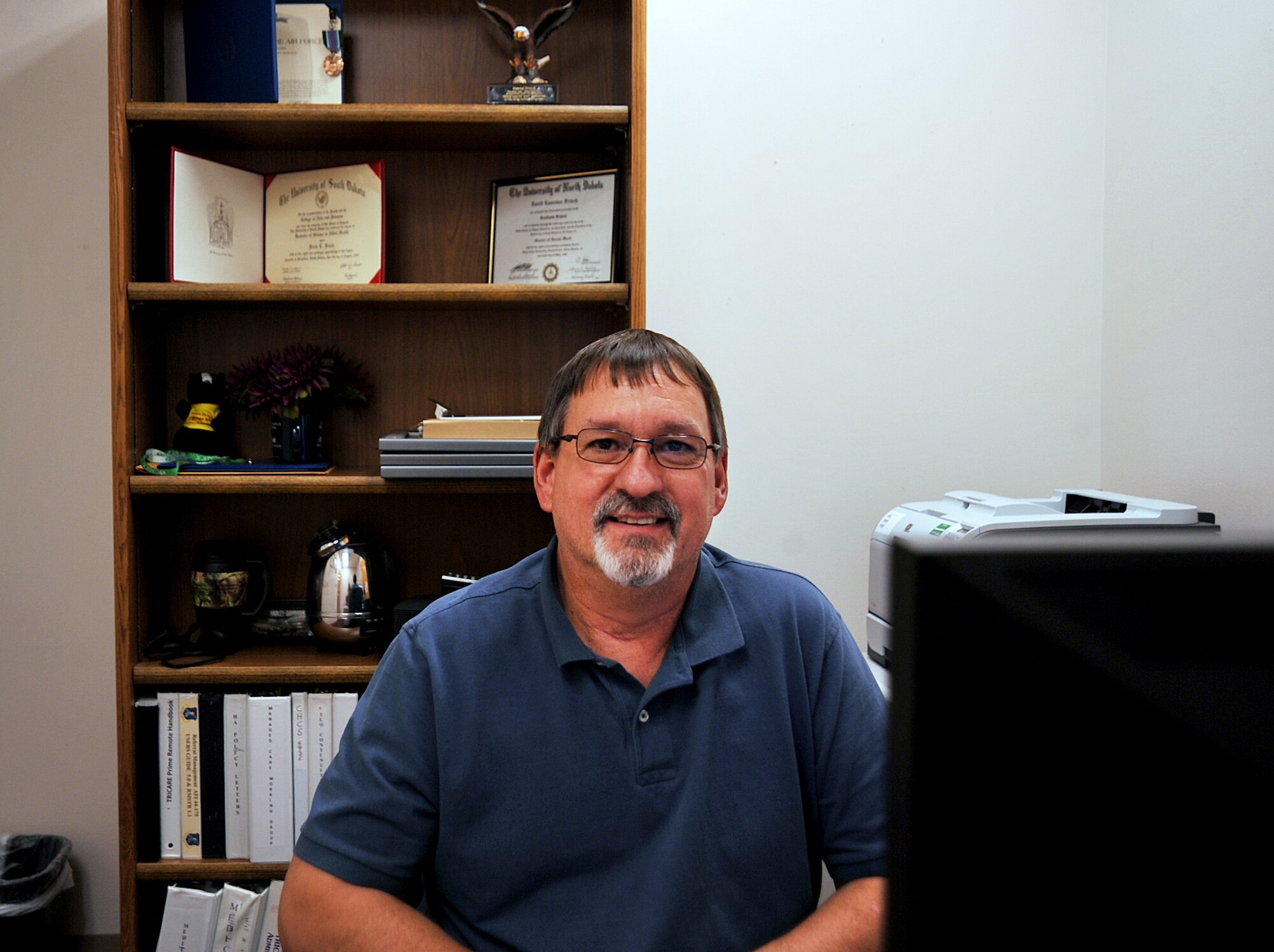 David Frisch, former Grand Forks Air Force Base Demand Reduction Program manager, pauses from his duties as the current 319th Medical Support Squadron TRICARE liaison officer, for a photograph on Grand Forks AFB, North Dakota Sept. 28, 2015. Frisch was the DRP manager when the program received the 25th Annual Secretary of Defense Community Drug Awareness Award for fiscal year 2014. (U.S. Air Force photo by Airman 1st Class Bonnie Grantham/released)