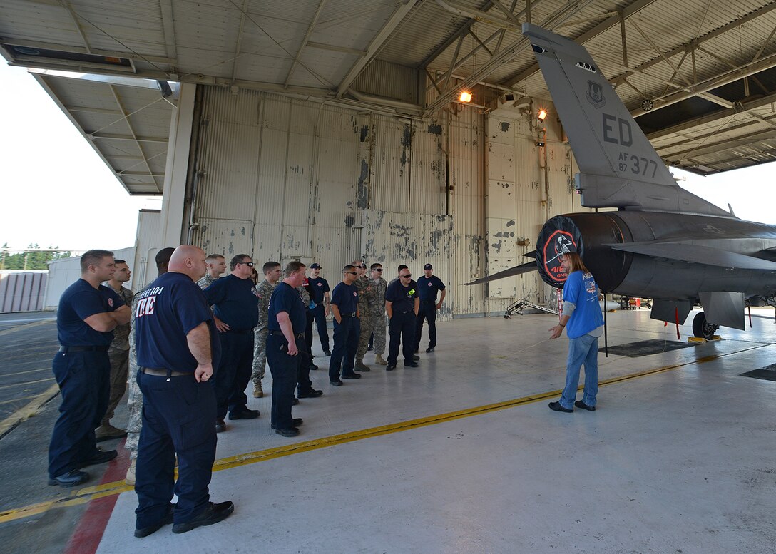 Chad Farmer, 412th Maintenance Squadron aircraft fuels systems trainer and lead, trains Joint Base Lewis-McChord, Wash., fire department personnel as part of initial training on how they should approach an aircraft during an initial hydrazine response, recovery and isolation incident. Farmer is just one of 20 Edwards AFB personnel temporarily assigned to JBLM in support of the KC-46 Tanker Program. (U.S. Air Force photo by Jet Fabara)
