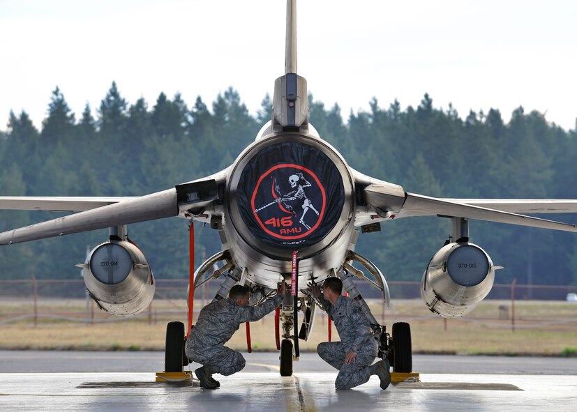 Senior Airman Andres Elias (left), 412th Aircraft Maintenance Squadron assistant dedicated crew chief, and Senior Airman Blake Holmes, 412 AMXS avionics specialist, conduct a walk-around inspection near the aft end of an F-16 Falcon Sept. 24, 2015, at Joint Base Lewis-McChord, Wash. The F-16s are attached to the 416 Flight Test Squadron at Edwards Air Force Base, Calif., but will act as photo and safety chase aircraft support for KC-46 flight test operations in Washington for the next 11 to 15 months. (U.S. Air Force photo/Jet Fabara) 