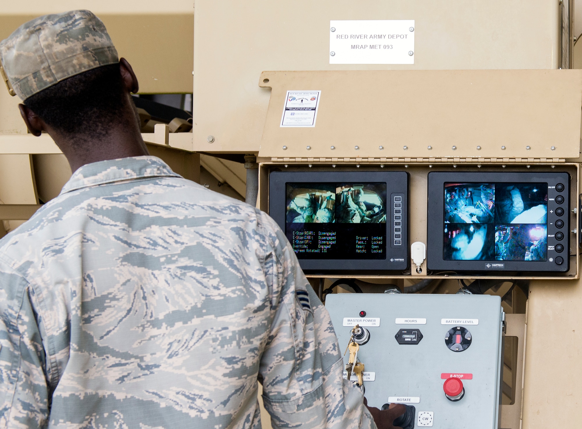 An Airman from the 820th Combat Operations Squadron operates a simulator as 23d Wing public affairs personnel participate in Mine Resistant Ambush Protected vehicle roll-over simulator training during Super Sports Day, Sept. 29, 2015, at Moody Air Force Base, Ga. The roll-over drill is designed to teach Airmen how to avoid panic after the vehicle rolls over while exiting quickly and safely. (U.S. Air Force photo by Airman 1st Class Greg Nash/Released)