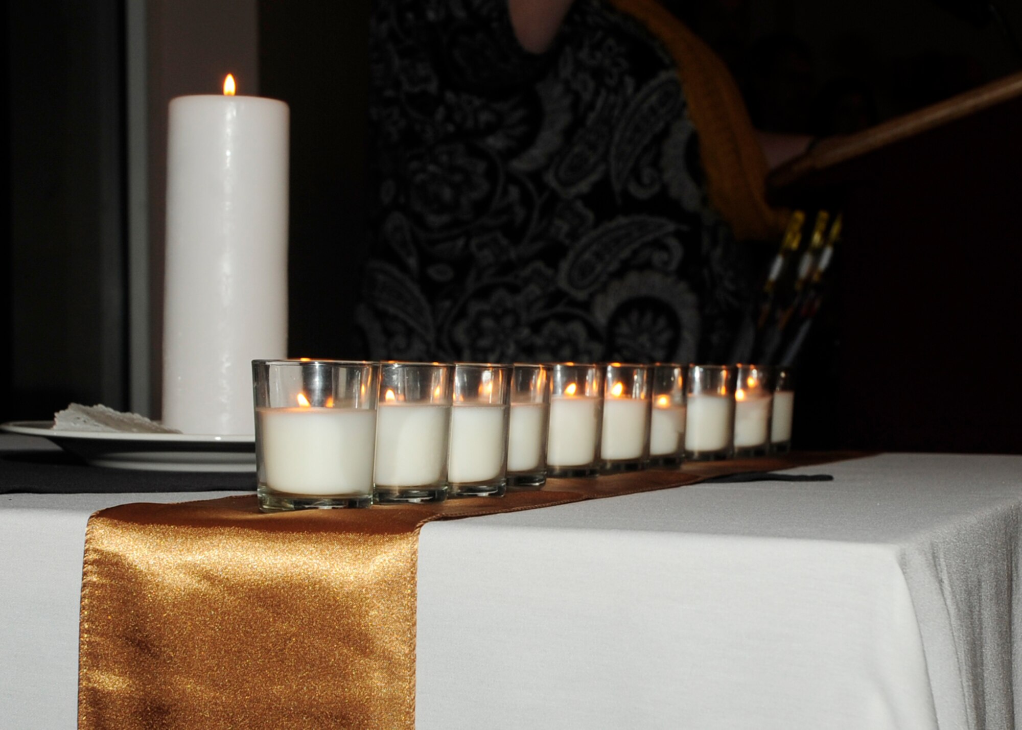 A still photograph of candles lit Sept. 26 at the 325th Fighter Group Checkertail Reunion.  Family members lit the candles to honor those of the 325th FG that are no longer living. (U.S. Air Force photo by Airman 1st Class Solomon Cook/ Released)