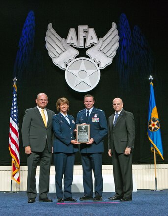 Col. Susan Melton and Lt. Col. Robert Taylor accept the Air Force Association Air National Guard Outstanding Unit Award for the 151st Maintenance Group at a ceremony in National Harbor, Md. on Sept. 14, 2015. (Photo by Brittany Gray/Released)