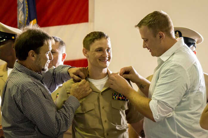 Electronics Technician Chief Petty Officer Joe Post gets his anchors pinned on by Senior Chief Electronics Technician (ret) Dale Stevick (left) and, his brother, Aviation Electrician’s Mate Petty Officer 1st Class Thomas Post at the Nuclear Power Training Unit, Joint Base Charleston – Weapons Station, Sept 16, 2015. The ceremony welcomed 25 new members to the Chief’s Mess. This is a significant milestone in every Sailor’s career, representing more than a century of heritage and tradition. (U.S. Navy photo/Machinist’s Mate Chief Petty Officer Justin D. Foil)