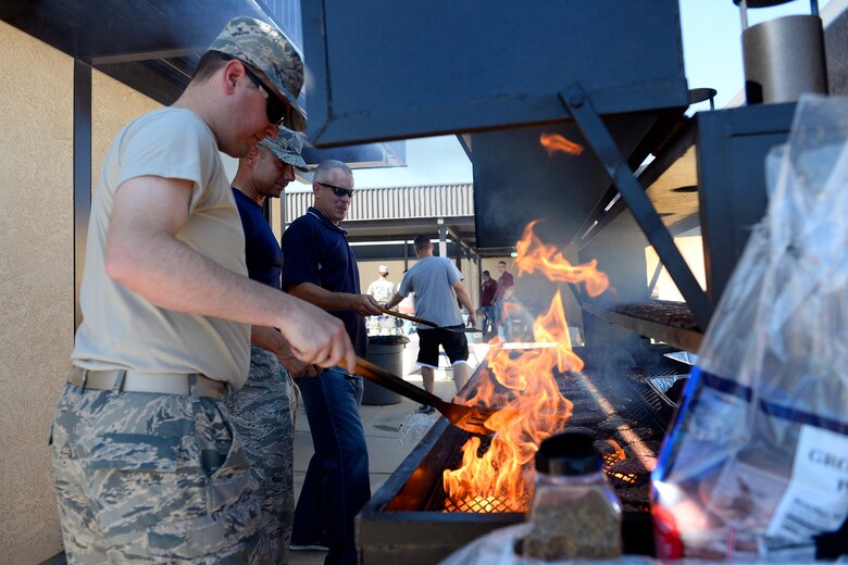 Chiefs from the 50th Space Wing prepare hot dogs, hamburgers and brats before the start of the Chiefs Barbecue at the fitness center pavilion at Schriever Air Force Base, Colorado, Friday, Sept. 25, 2015. After the barbecue, the chiefs went on to play the colonels in a Chiefs vs. Eagles Volleyball three-game tournament which wrapped up the Schriever Week events celebrating Schriever/Falcon AFB’s 30th anniversary. (U.S. Air Force photo/Christopher DeWitt)