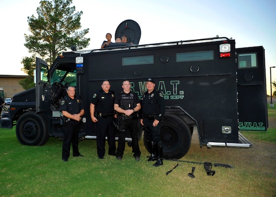 Police offers from the Glendale Police Department pose with their Special Weapons and Tactics truck and children during the Deployed Family Day September 25, 2015, at Fowler Park on Luke Air Force Base, Arizona. The 56th Force Support Squadron held its monthly event, “Hearts Apart” for families who have been separated by deployments or who are remote spouses and was sponsored by the Glendale P.D. (U.S. Air Force photo by Staff Sgt. Marcy Copeland)