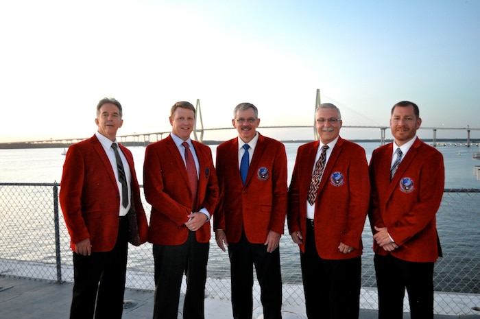 (Left to Right) Master Sgt. (ret) Gordon MacDougall, Lt. Col. (ret) Marc Tessier, Master Sgt. (ret) Jim Cheesborough, Maj. Gen. (ret) Martin M. Mazick and Master Sgt. (ret) Rene “Red” Delarosa pose for a group photo after being inducted into the Global Eagle Hall of Fame on the USS Yorktown in Charleston, S.C., Sept. 19, 2015. The Hall of Fame was established to recognize the significant achievements of its members to the community, the unit and the global mobility mission. Starting a new tradition, members inducted this year received a bright red blazer with the 15th AS Heritage patch emblazoned on the chest.