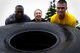 U.S. Air Force Airmen flip a tire during a 20th Fighter Wing Comprehensive Airman Fitness week obstacle course at Shaw Air Force Base, S.C., Sept. 25, 2015. After flipping the tire, Airmen had to accomplish three additional obstacles to complete to course. (U.S. Air Force photo by Senior Airman Jensen Stidham/Released) 