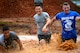 U.S. Air Force Airmen run through a mud pit during a 20th Fighter Wing Comprehensive Airman Fitness week obstacle course at Shaw Air Force Base, S.C., Sept. 25, 2015. Airmen were challenged throughout the event by a series of eight obstacles meant to test the physical domain of CAF. (U.S. Air Force photo by Senior Airman Jensen Stidham/Released)  