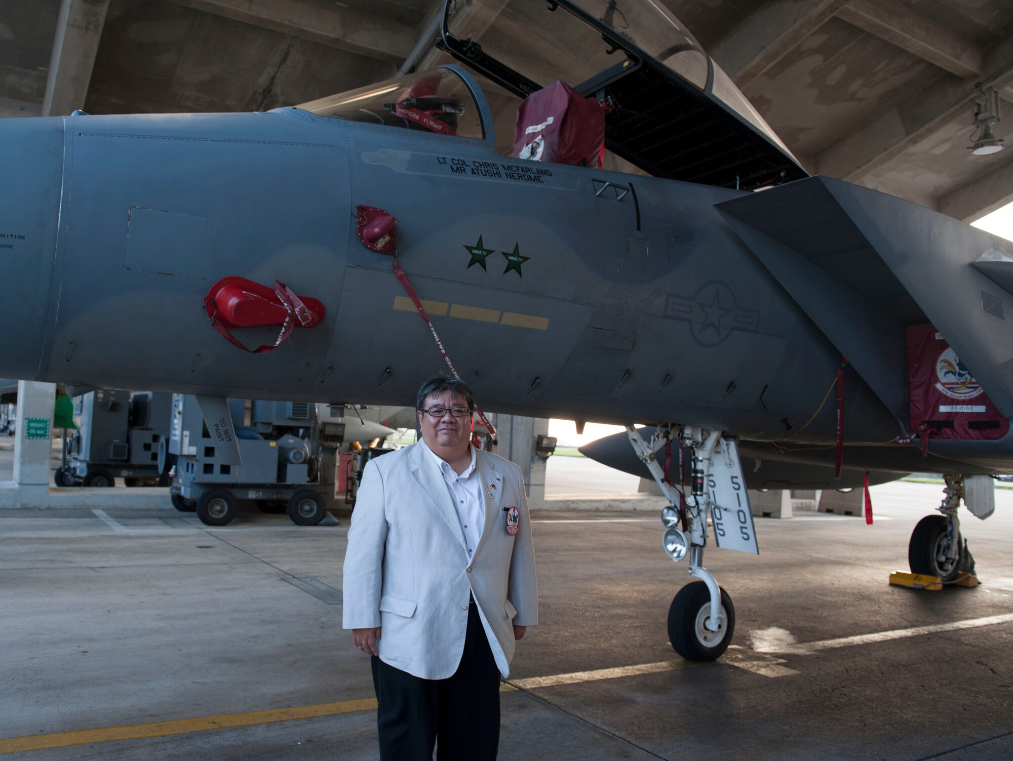 Atushi Nerome, 67th Fighter Squadron  honorary commander, stands in front of an F-15 Eagle honoring his position during an honorary commander tour Sept. 29, 2015, on Kadena Air Base, Japan. The honorary commander program has been utilized by Kadena for 14 years. This year’s tour allowed the honorary commanders the opportunity to see many of the processes that go into maintaining Kadena’s aircraft. It provided the commanders the opportunity to ask questions about the operations of Kadena and the processes in place to ensure the safety of the aircraft.(U.S. Air Force photo by Airman 1st Class Lynette M. Rolen)