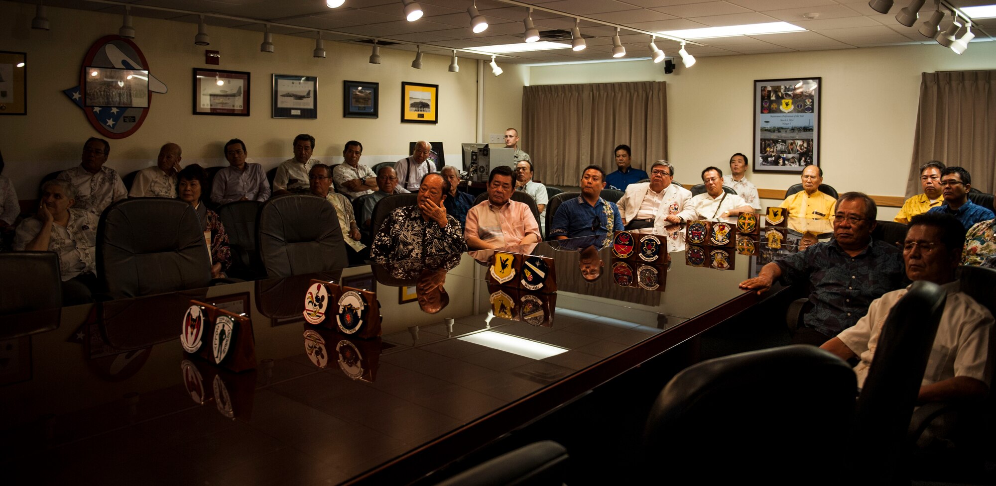Kadena’s honorary commanders listen to a briefing about Kadena Air Base during a tour Sept. 29, 2015, on Kadena Air Base, Japan. The honorary commander program is designed to build better relationships and reinforce ties between the U.S. military and local community. The briefing was on the 18th Maintenance Group’s mission and how it is accomplished.  The 18th MXG ensures that the F-15 Eagles are maintained 24/7 so they are ready to help maintain strategic access and freedom of movement across all domains in the Indo-Asia-Pacific region. It is important that the aircraft are properly maintained in order to protect and defend Kadena’s partners and allies. (U.S. Air Force photo by Airman 1st Class Lynette M. Rolen)