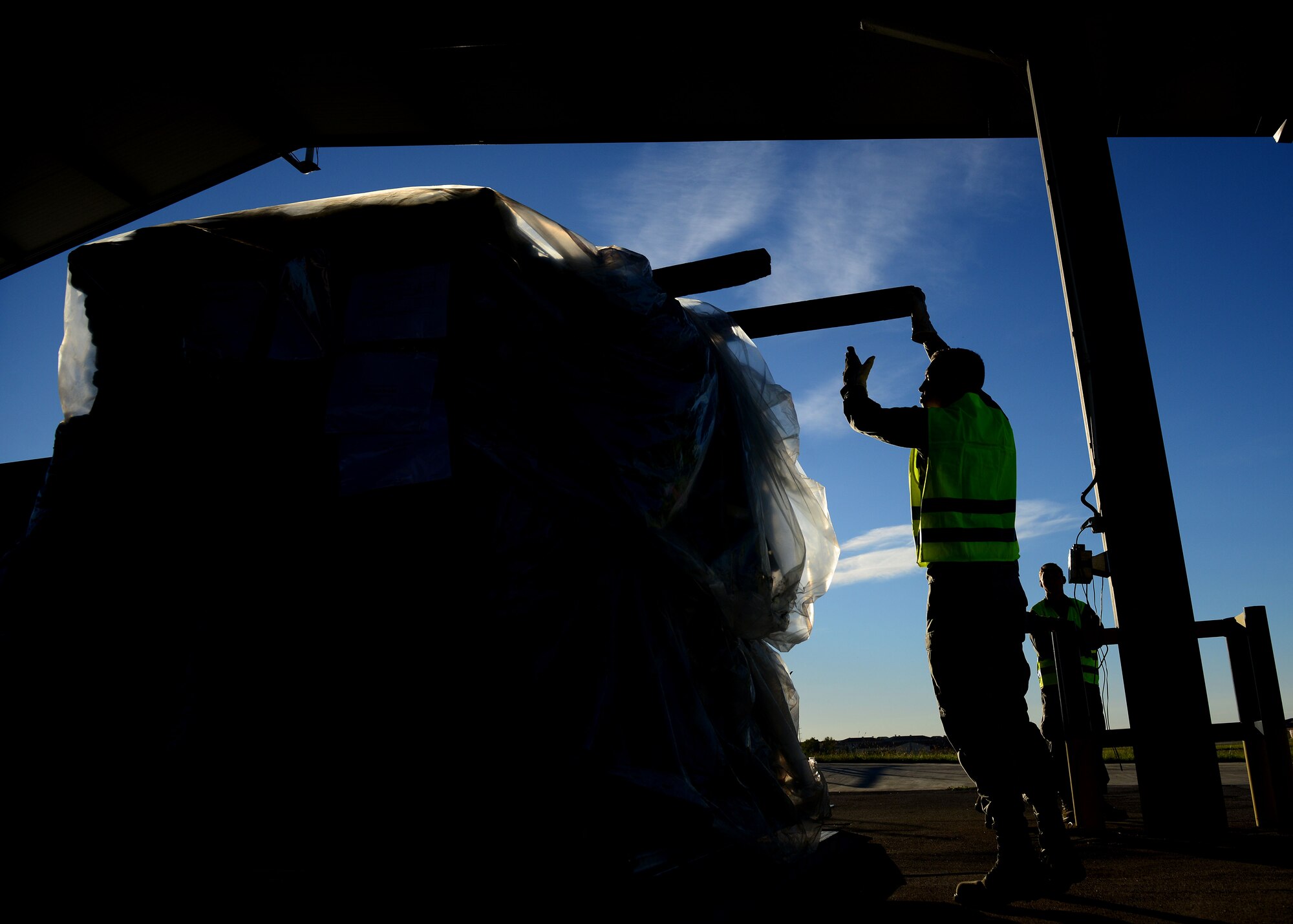 A U.S. Air Force Airman secures cargo during a cargo rodeo, Sept. 29, 2015, at Aviano Air Base, Italy. Cargo rodeos are conducted twice a year to exercise the 31st Fighter Wing Deployment Control Center’s deployment readiness. (U.S. Air Force photo by Staff Sgt. Evelyn Chavez/Released)