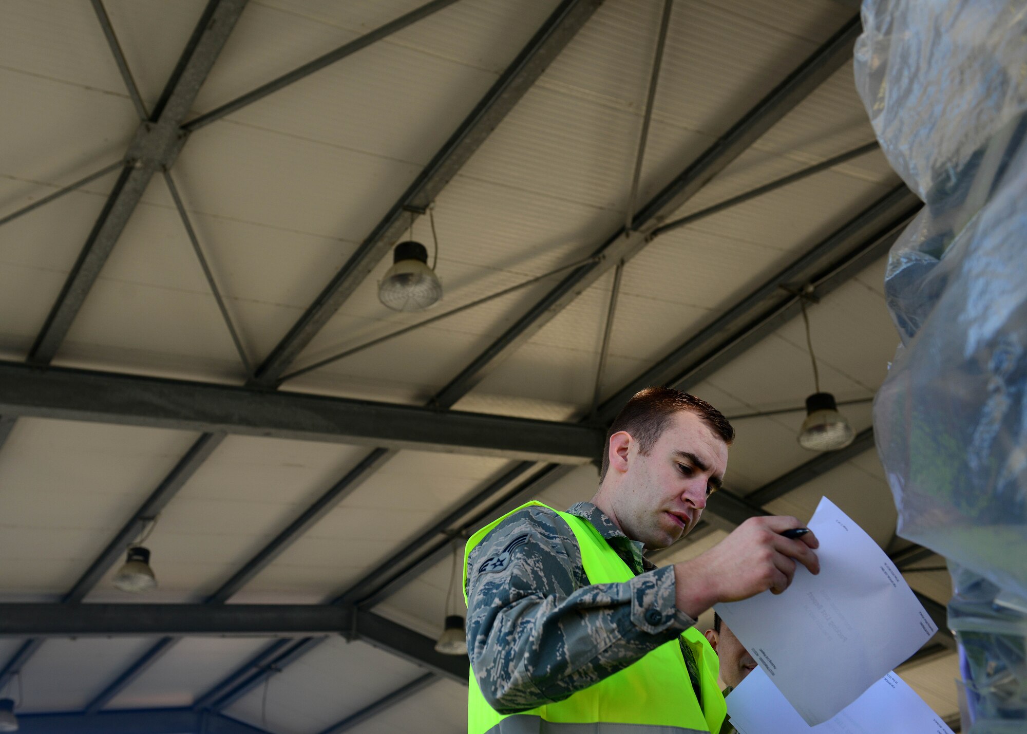 U.S. Air Force Senior Airman Josh Gurd, 31st Logistics Readiness Squadron traffic management office personal property journeyman, checks an item list during a cargo rodeo, Sept. 29, 2015, at Aviano Air Base, Italy. Cargo rodeos are conducted twice a year to exercise the 31st Fighter Wing Deployment Control Center’s deployment readiness. (U.S. Air Force photo by Staff Sgt. Evelyn Chavez/Released)