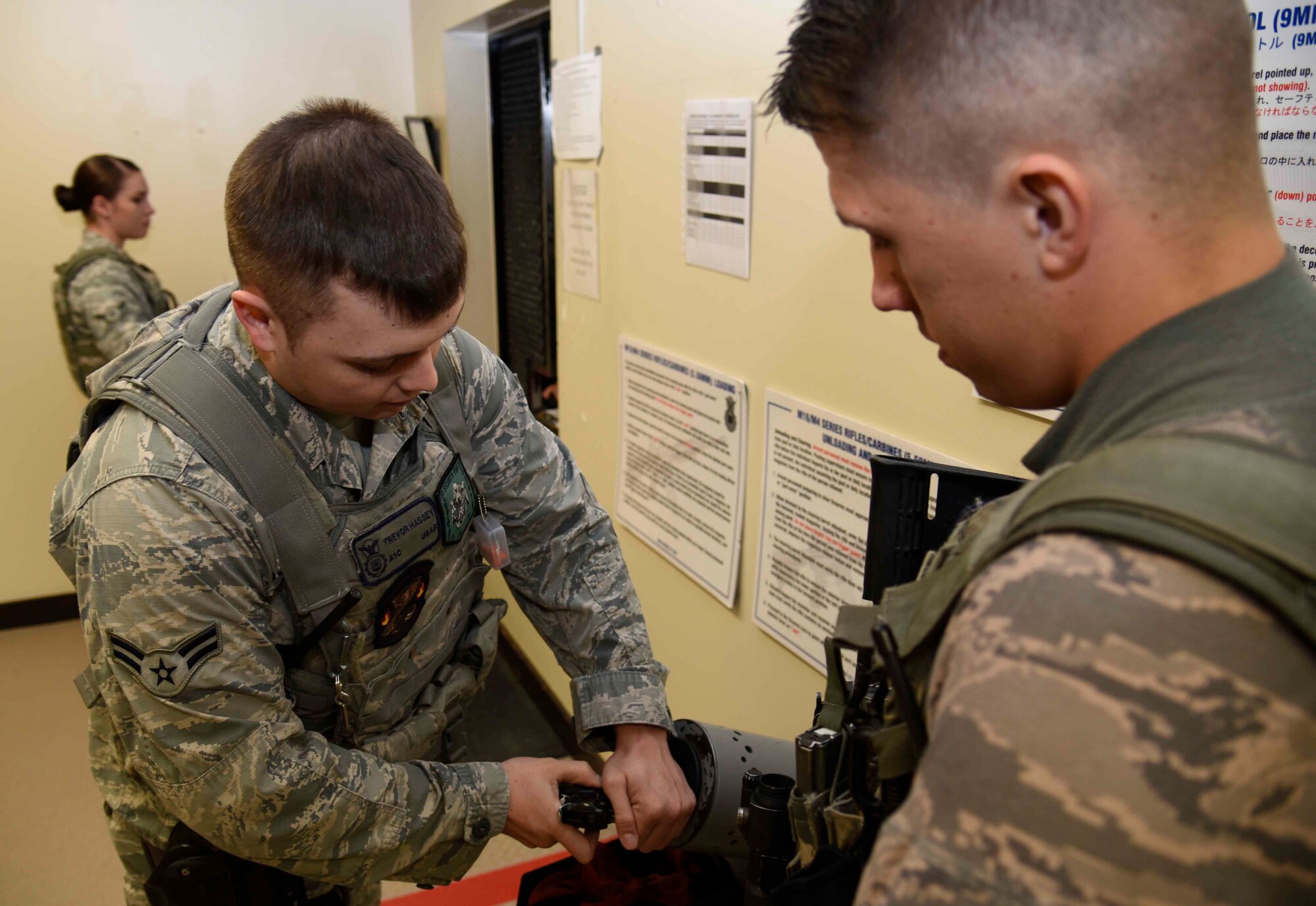 U.S. Air Force Airman 1st Class Trevor Hassey, 35th Security Forces Squadron alarm monitor, clears his weapon at Misawa Air Base, Japan, Sept. 29, 2015. Hassey monitors the base alarm system to identify any potential security breaches. (U.S. Air Force photo by Senior Airman Jarrod Vickers/Released)