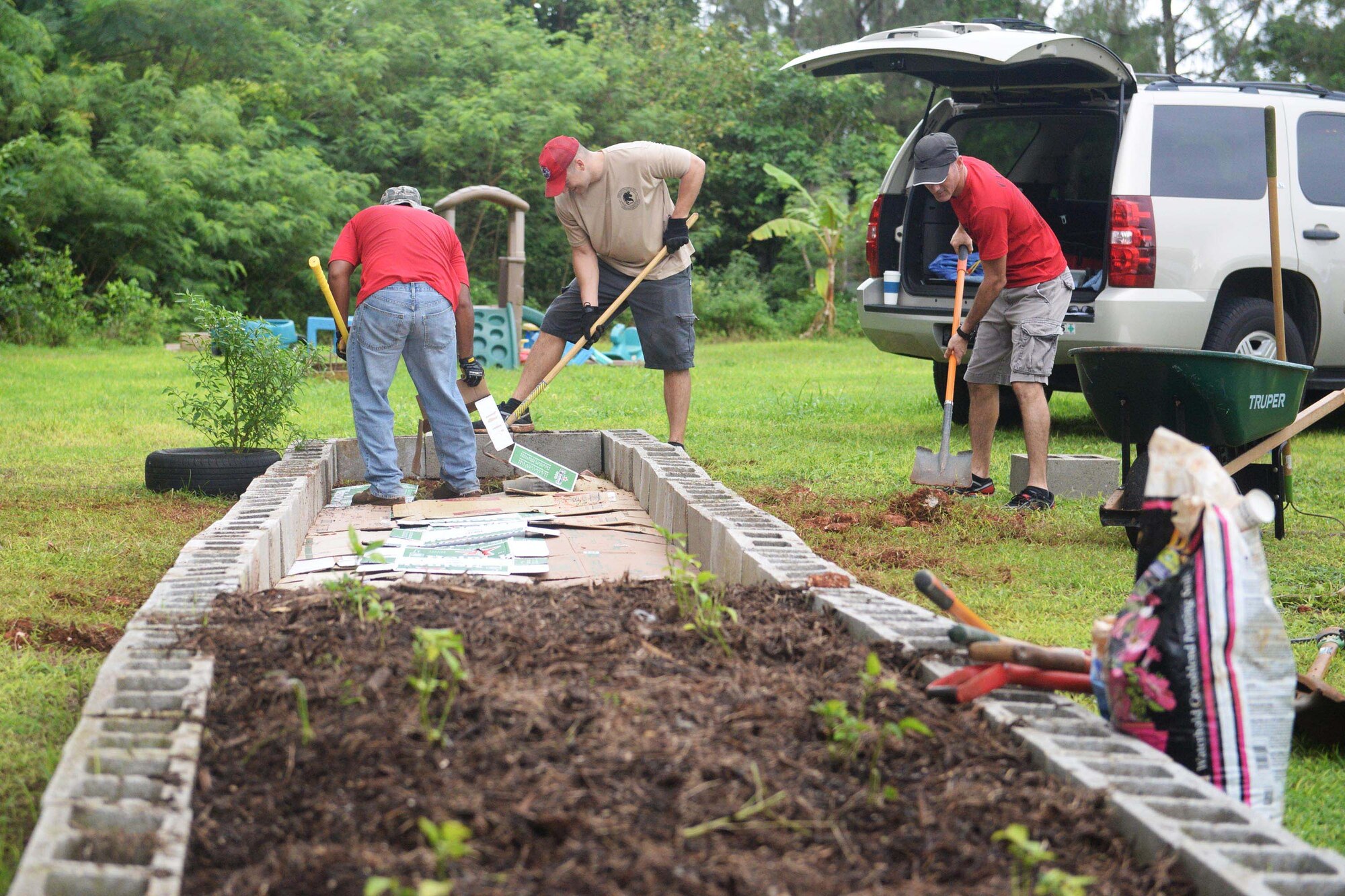 Airmen assigned with the 554th RED HORSE expand a garden Sept. 26, 2015, at the Guma San Jose Homeless Shelter, Dededo, Guam. The team offered specialized services to assist with the shelter’s electrical, plumbing and air conditioning issues. Crews also expanded a garden to allow residents to grow their own fruits and vegetables and develop healthy eating habits. (U.S. Air Force photo by Senior Airman Joshua Smoot/Released)