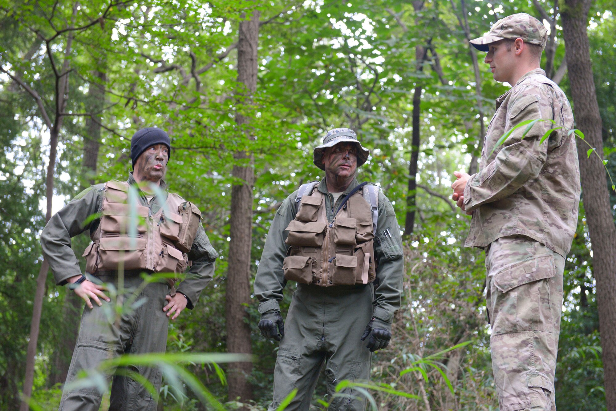 (Right) Staff Sgt. Robert Rogers, 374th Operations Support Squadron Survival, Evasion, Resistance and Escape specialist, advises participants in the combat survival course at Tama Hills Recreation Area, Japan, Sept. 24, 2015. According to Rogers, SERE training pushes participants to their physical and mental limits and teaches them how to overcome adversity. (U.S. Air Force photo by Airman 1st Class Elizabeth Baker/Released)