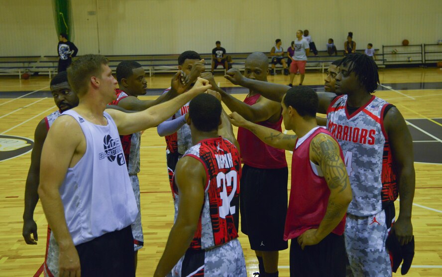 Members for the Yokota Warriors team huddle during a timeout during the third quarter of a basketball game against the Saitama Hedges at Yokota Air Base, Japan, Sept. 26, 2015. Yokota built a commanding 80-51 lead before the third quarter ended, winning the game 97-71. (U.S. Air Force photo by Senior Airman David Owsianka/Released)