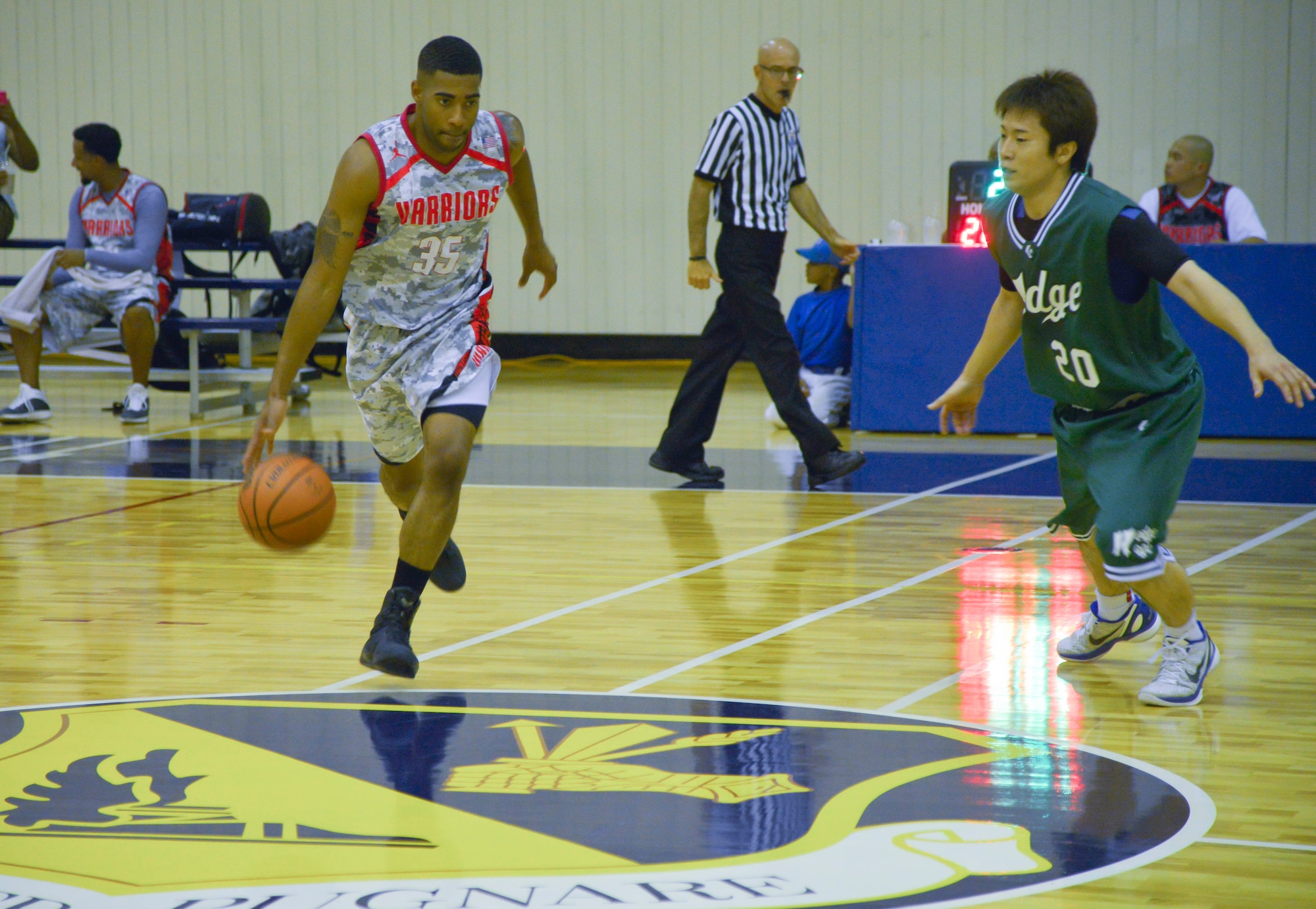 Randall Ard dribbles the ball down court during the second quarter of a basketball game against the Saitama Hedges at Yokota Air Base, Japan, Sept. 26, 2015. Yokota used their size and speed to attack the basket and play tough defense, only allowing the Hedges to take one shot per most offensive possessions. (U.S. Air Force photo by Senior Airman David Owsianka/Released)