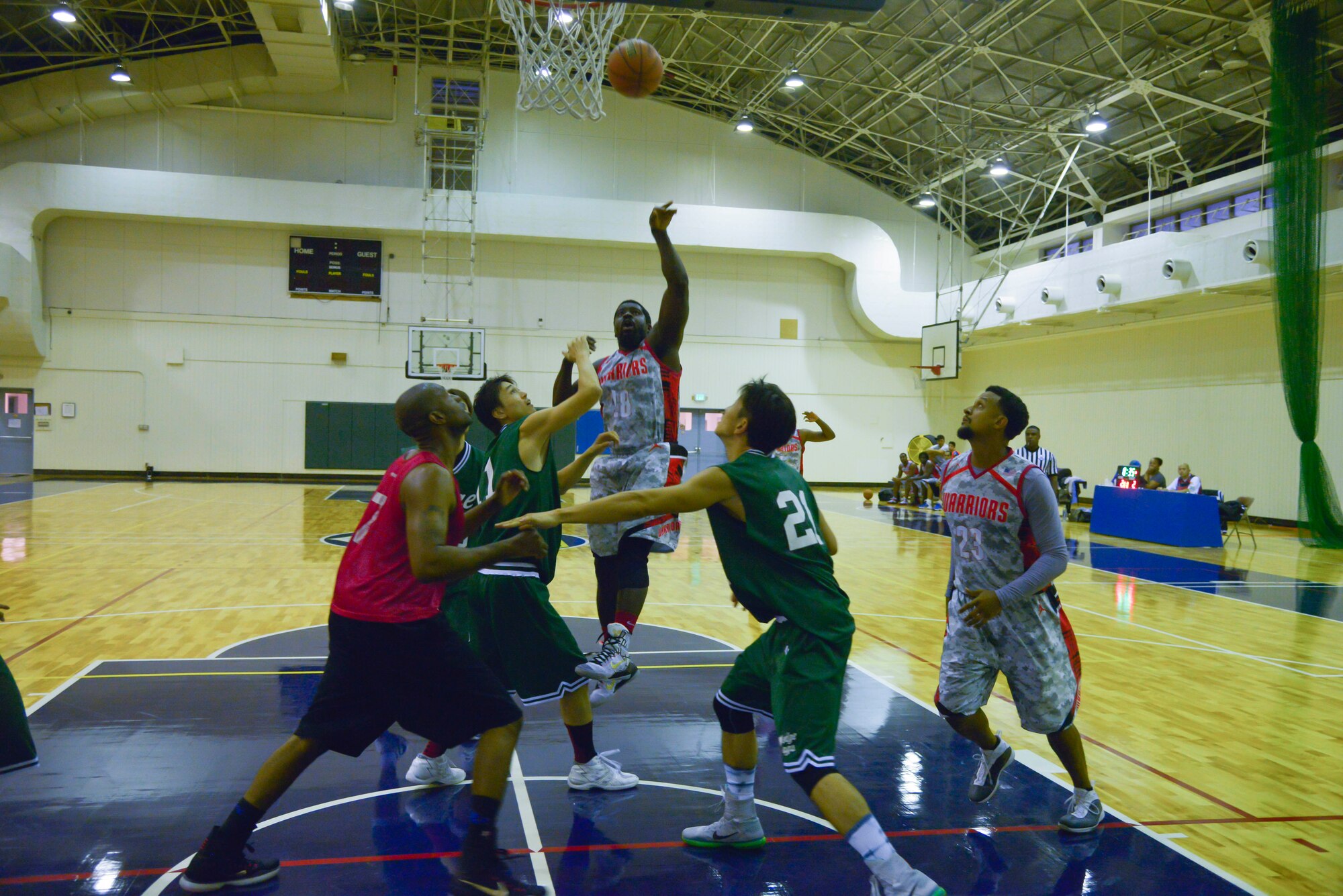 William Brown shoots the ball over a group of defenders during the first quarter of a basketball game against the Saitama Hedges at Yokota Air Base, Japan, Sept. 26, 2015. The Warriors jumped to an early lead by going on an 11-4 run in the first three minutes of the game. (U.S. Air Force photo by Senior Airman David Owsianka/Released)