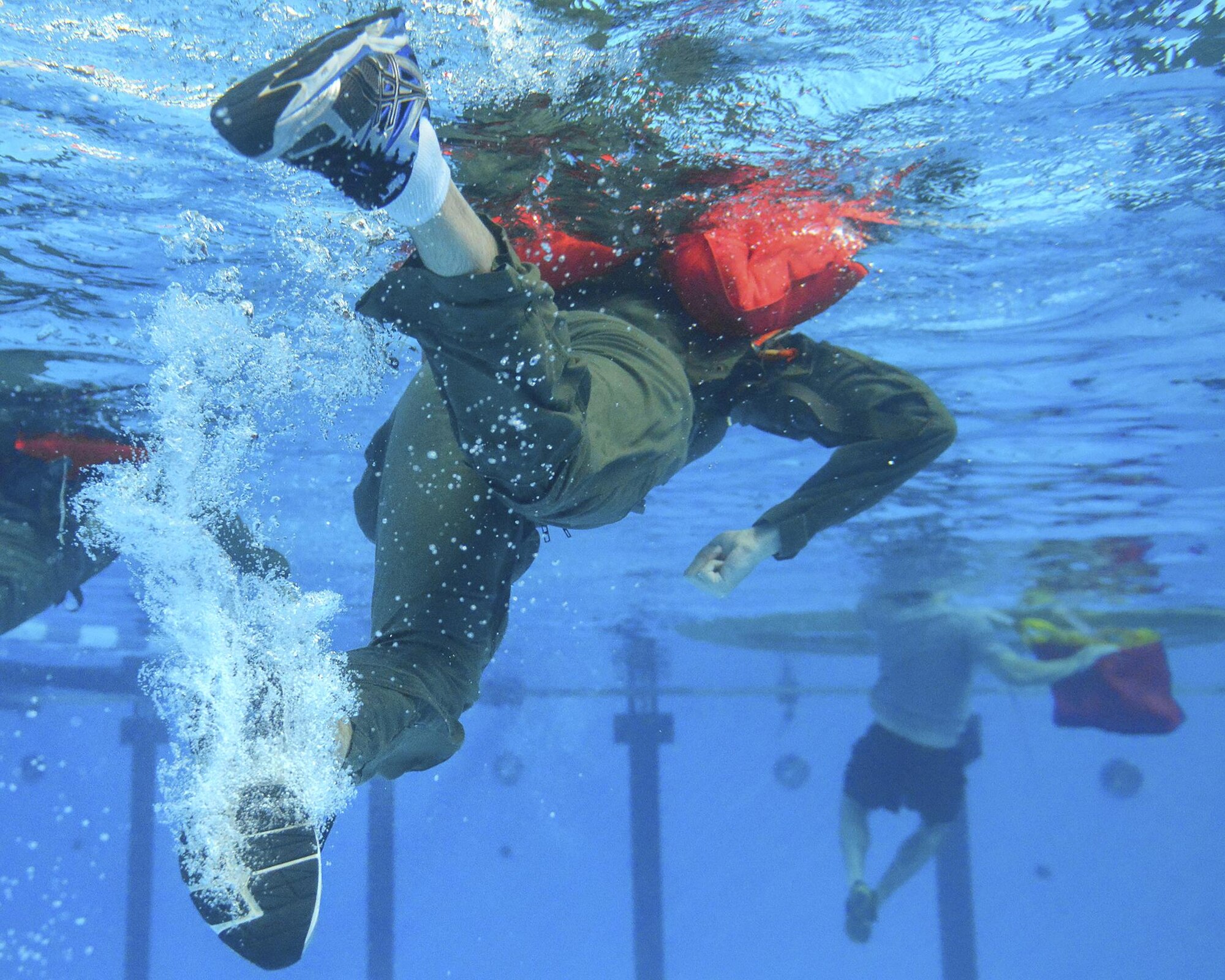 Participants in the Survival, Evasion, Resistance and Escape water survival course swim toward a life raft at Yokota Air Base, Japan, Sept. 22, 2015. The water survival course familiarizes students with the equipment and procedures used in the event of an aircraft emergency. (U.S. Air Force photo by Airman 1st Class Elizabeth Baker/Released)