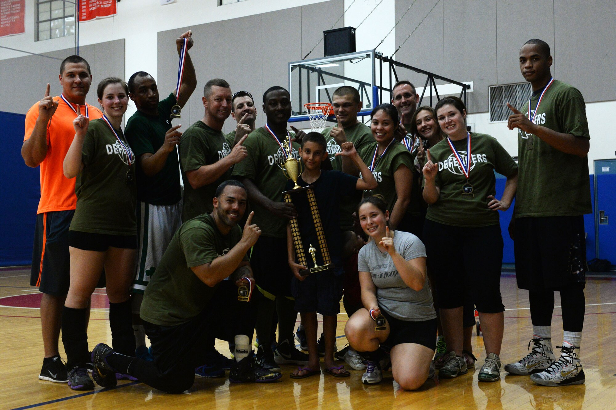 Airmen assigned to the 36th Security Forces Squadron celebrate winning first place in the 2015 intramural volleyball championship Sept. 29, 2015, at Andersen Air Force Base, Guam. The team beat their opponents of the 36th Operations Support Squadron 15-7 in a tiebreaker set. (U.S. Air Force by Senior Airman Joshua Smoot/Released)