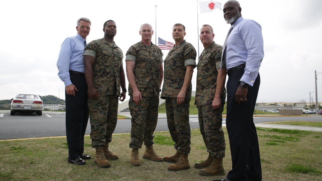 Okinawa based Marines and Department of Defense personnel pose for a photograph March 31 aboard Camp Foster, Okinawa, Japan. The gentlemen were on board a flight leaving Honolulu heading toward Tokyo when an unruly passenger began to threaten fellow passengers. The four Marines and two civilians quickly jumped into action and peacefully apprehended the hostile passenger until he was turned over to Honolulu sheriff’s department. The Okinawa based personnel are with Marine Corps Installations Pacific and III Marine Expeditionary Force.