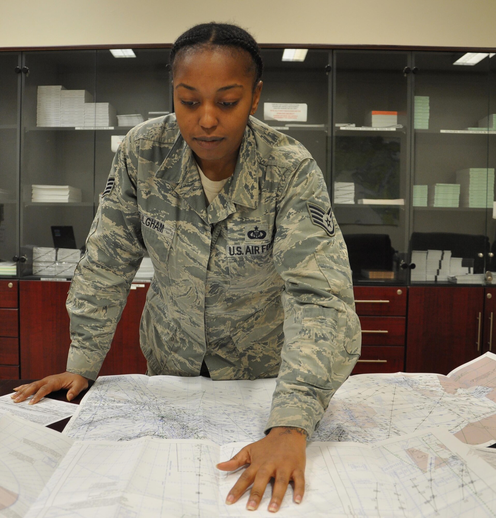 Staff Sgt. Talia Fulgham, 379th Expeditionary Operations Support Squadron Airfield Management operations noncommissioned officer in charge from Alliance, Ohio, looks at a map at Al Udeid Air Base, Qatar March 17. As the NCOIC of the 379 EOSS Airfield Management office, Fulgham is responsible for ensuring all flight plans are filed properly. She uses maps, like the one pictured here, to identify discrepancies with submitted flight plans. The 379 EOSS Airfield Management team reviewed more than 20,000 flight plans in 2015. (U.S. Air Force photo by Tech. Sgt. James Hodgman/Released)