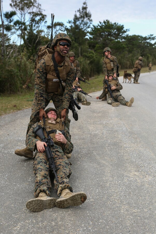 U.S. Marine Corps Sgt. Kevin Allen, an oboe player with III Marine Expeditionary Force Band, buddy drags a casualty during a patrol on Camp Hansen, Okinawa, Japan, Jan. 31, 2016. CPX 16 is conducted to improve the III MEF’s capabilities in intelligence and logistic operations, future planning, and combat readiness. (U.S. Marine Corps photo by MCIPAC Combat Camera Lance Cpl. Christian J. Robertson/Released)