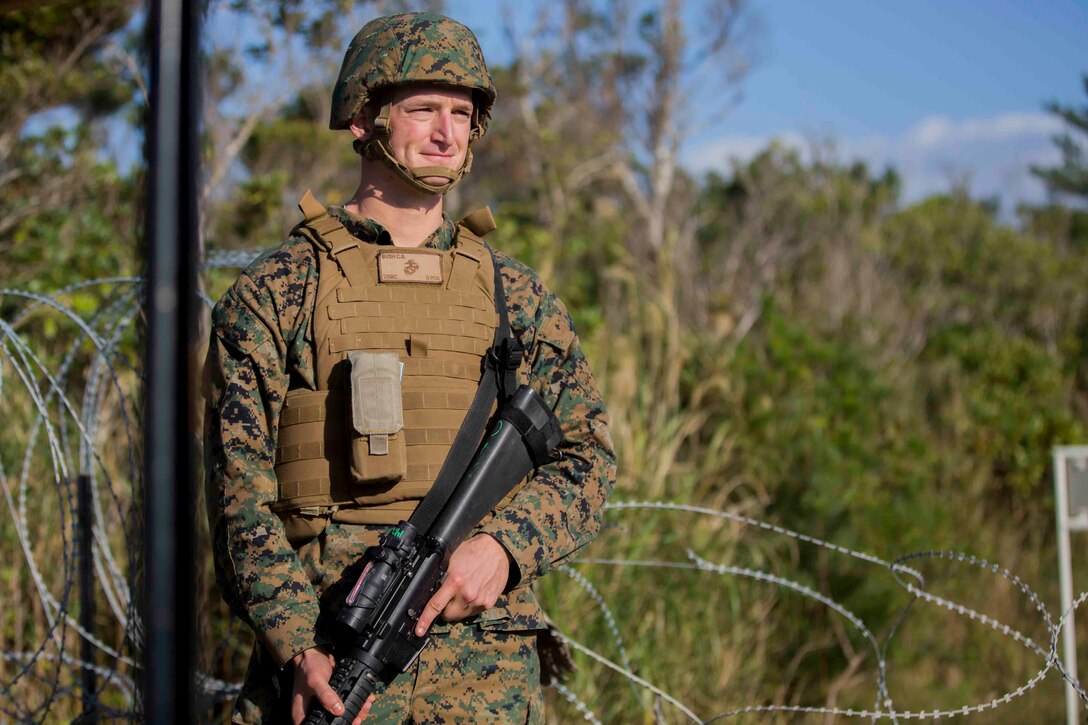 U.S. Marine Corps Cpl. Carl S. Bush, an instrumentalist with the III Marine Expeditionary Force band, provides gate security during CPX 16 on Okinawa, Japan, Jan. 31, 2016. CPX 16 is conducted to improve the III MEF capabilities in intelligence and logistic operations, future planning, and combat readiness. (U.S. Marine Corps photo by MCIPAC Combat Camera Lance Cpl. Juan Bustos/ Released)