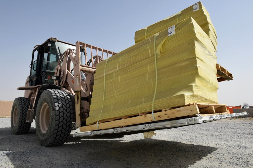 Senior Airman Quincy Petty, an inbound cargo journeyman assigned to the 386th Expeditionary Logistics Readiness Squadron, moves cargo at an undisclosed location in Southwest Asia, March 22, 2016. The 386th ELRS deployment and distribution flight is responsible packing, shipping and transporting cargo such as base supplies and equipment throughout the installation as well as to nearby bases. (U.S. Air Force photo by Staff Sgt. Jerilyn Quintanilla)