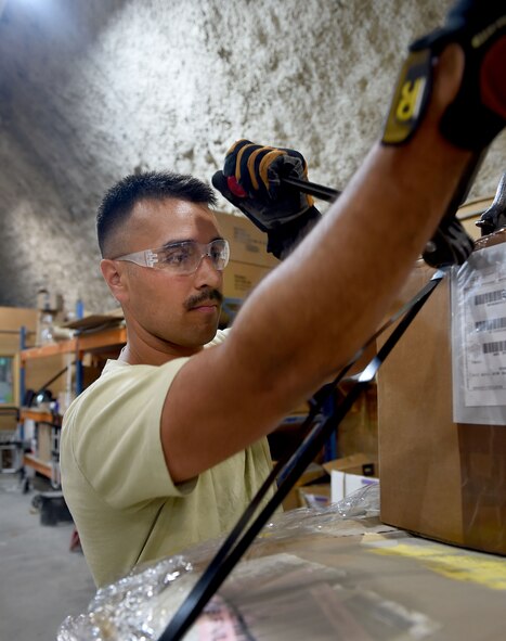 Staff Sgt. Manuel Fralick, a 386th Expeditionary Logistics Readiness Squadron packing and crating supervisor secures cargo to a pallet for transport at an undisclosed location in Southwest Asia, March 22, 2016. The deployment and distribution flight packs and ships approximately 180 tons of cargo throughout the area of responsibility each month. (U.S. Air Force photo by Staff Sgt. Jerilyn Quintanilla) 