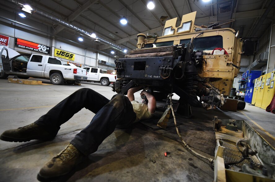 Senior Airman Jeremy Lee, a 386th Expeditionary Logistics Readiness Squadron vehicle maintenance technician, lowers the half shafts to gain access to brake pads on a High Mobility Multipurpose Wheeled Vehicle at an undisclosed location in Southwest Asia, March 14, 2016. The vehicle maintenance flight conducts maintenance on the entire 386th AEW fleet comprised of more than 660 vehicles. (U.S. Air Force photo by Staff Sgt. Jerilyn Quintanilla)