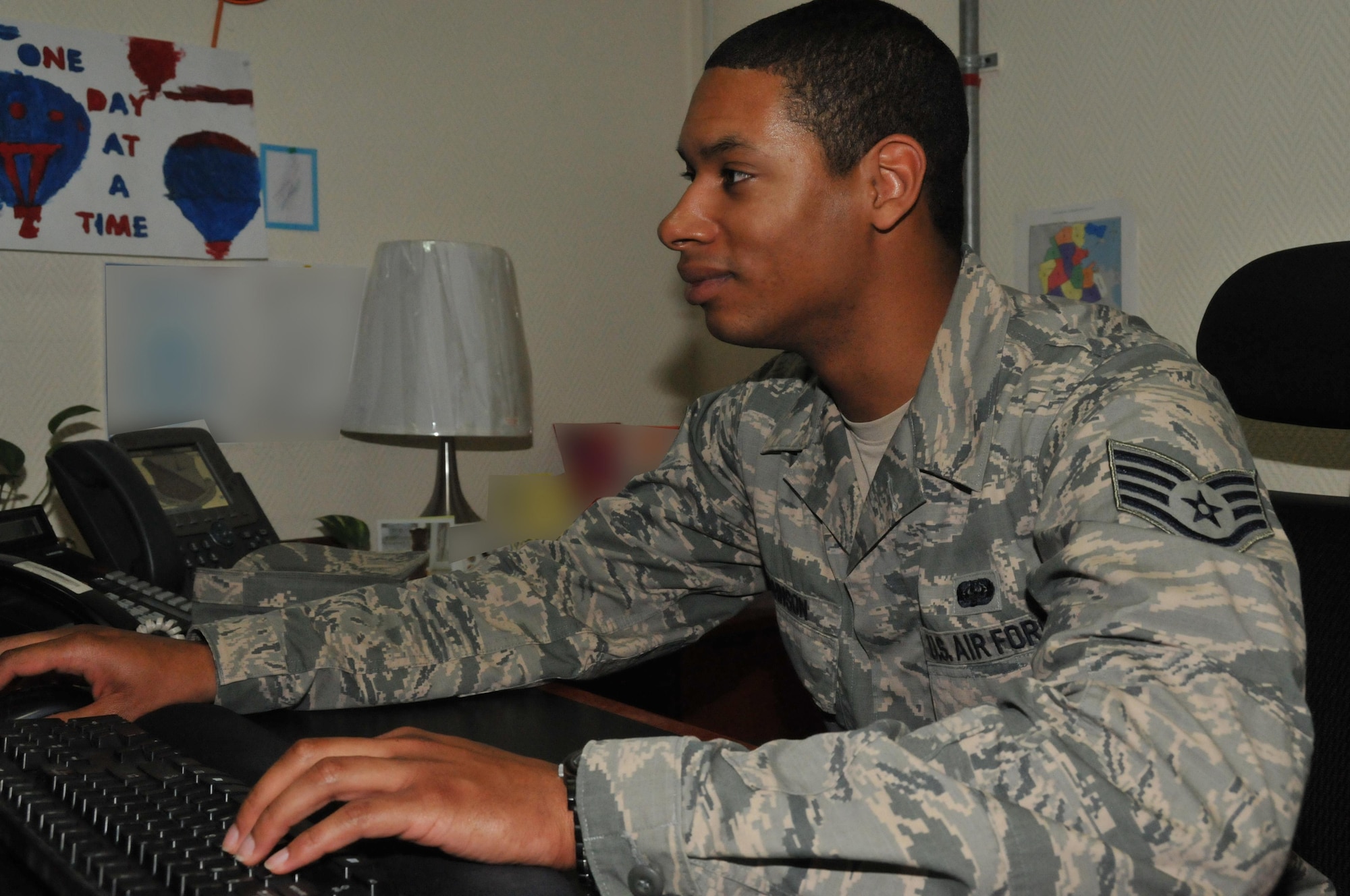 Staff Sgt. Aaron Johnson, 379th Expeditionary Communications Squadron Cyber Surety specialist, responds to network request emails sent from personnel March 18 at Al Udeid Air Base, Qatar. (U.S. Air Force photo by Tech. Sgt. Terrica Y. Jones)