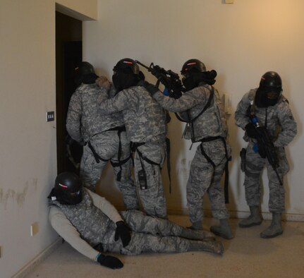 Airmen assigned to the 879th Expeditionary Security Forces Squadron at Eskan Village, Southwest Asia, clear a building during a training exercise March 25. Training exercises help first responders maintain their readiness level. Explosive ordnance technicians, medics and emergency management professionals also participated in the exercise. (U.S. Air Force photo by Tech. Sgt. James Land)