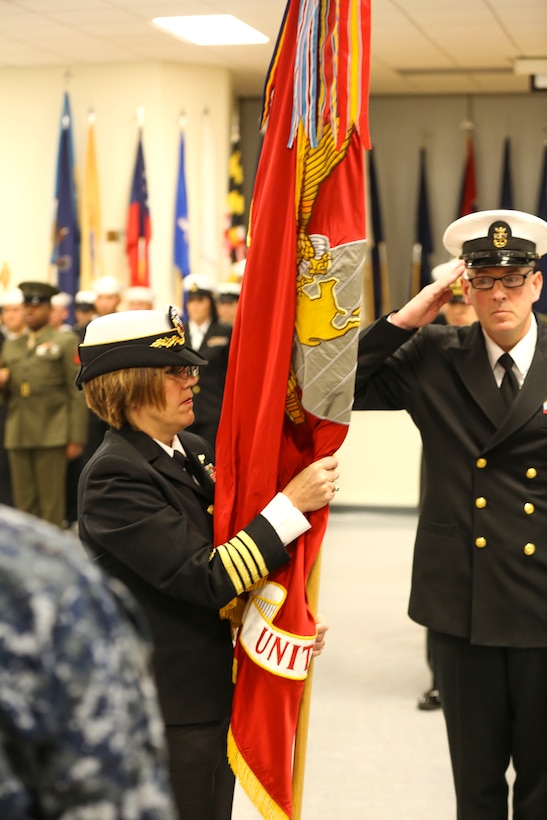 Navy Capt. Jennifer Smith, commanding officer of Field Medical Training Battalion, receives the colors during a change of command ceremony at Marine Corps Base Camp Lejeune at Camp Johnson Friday. Smith took command as the first female commander for the battalion, after Navy Capt. Richard Jehue retired from 31 years of service in the Marine Corps and Navy. 