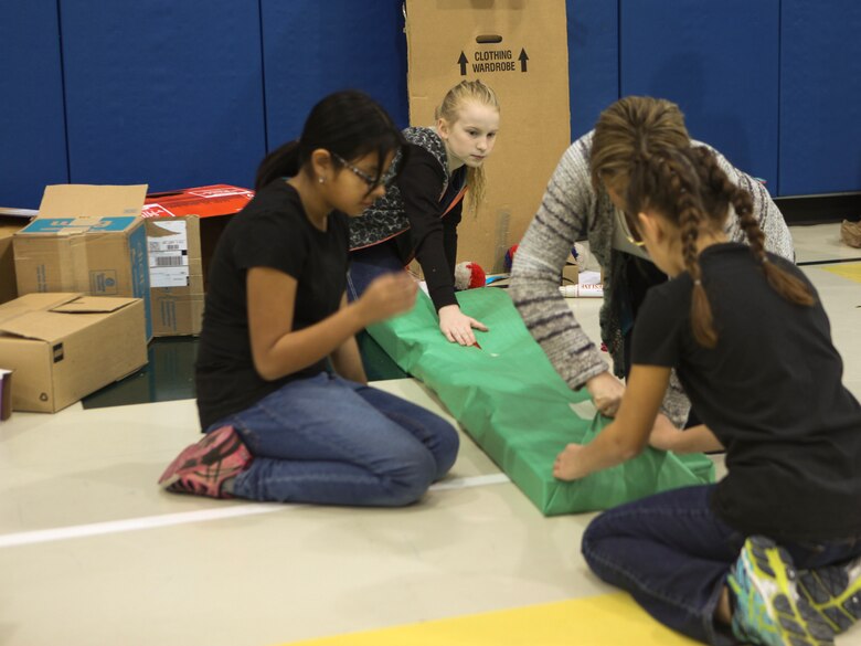 Students at DeLalio Elementary School participate in the Cardboard Box Challenge, a global Science, Technology, Engineering and Math education event, March 10. After creating an arcade out of cardboard and other recyclable materials, the students invited friends in family to come play the games.
