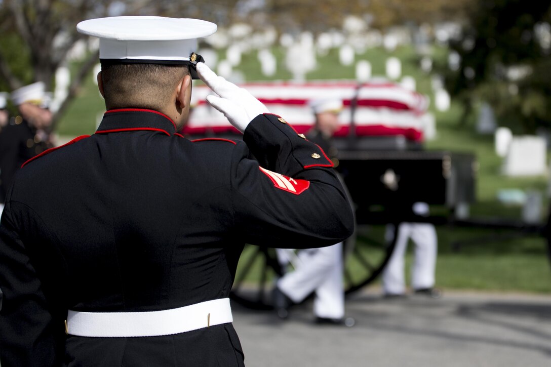 A Marine from Marine Barracks Washington, D.C., salutes Gen. Earl Edward Anderson, during his full honors funeral at Arlington National Cemetery, Va., March 31, 2016. Anderson was the first active duty Marine Naval Aviator to be promoted to a four-star rank, and he became the assistant commandant of the Marine Corps on April 1, 1972.
