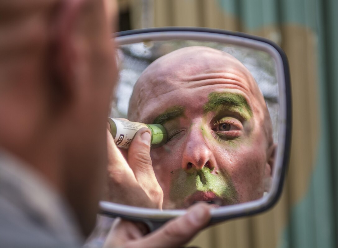 Staff Sgt. Brian Dolan, Co. B, Special Troops Bn., 171st Inf. Bde., applies camouflage to his face and equipment during the third day of testing at the Expert Infantry Badge qualification held on Ft. Jackson, S.C., March 31, 2016. Soldiers vying for the coveted Infantry qualification were given 30 timed Army Warrior tasks to complete in addition to being tested on the Army Physical Fitness test, day and night land navigation. Testing ends on April 1 with a 12-mile forced march. (U.S. Army photo by Sgt. 1st Class Brian Hamilton/released)