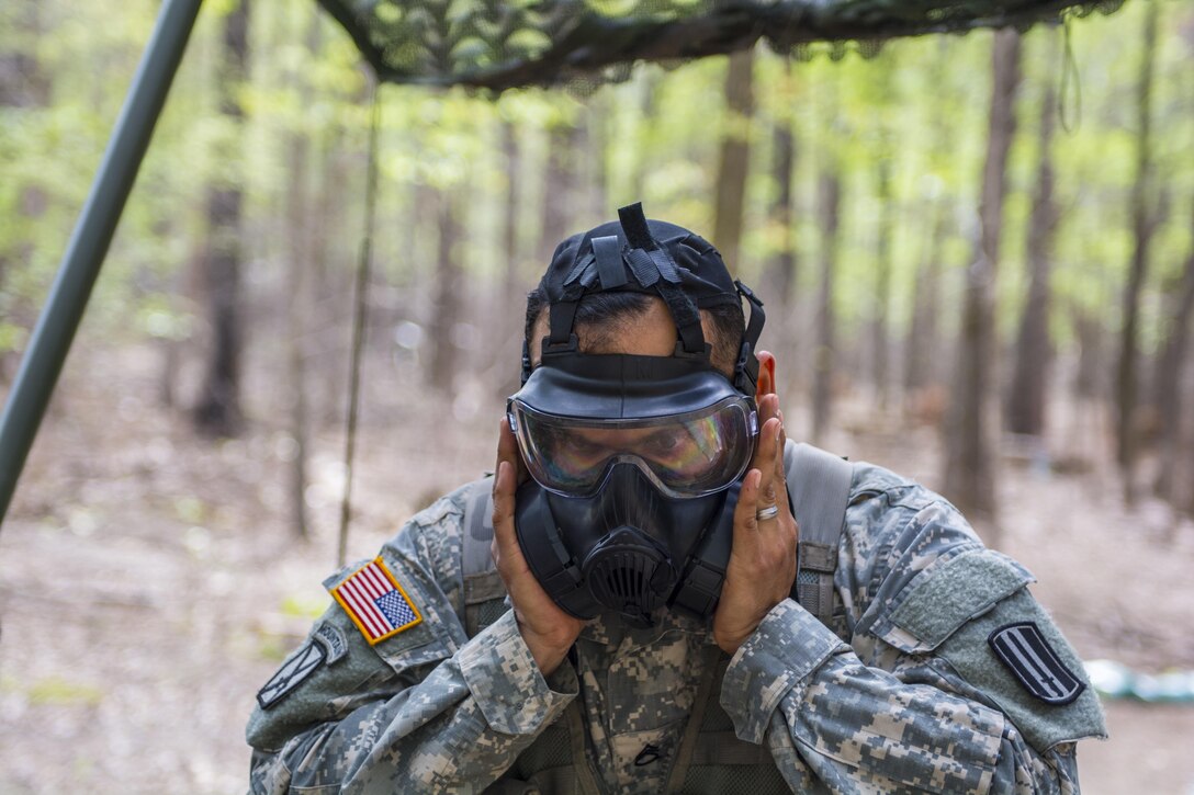 Staff Sgt. Juan Salgado, Co. A., 3rd Bn. 60th Inf. Reg., checks the seal on his protective mask during round robbin testing at the Expert Infantry Badge qualification held on Ft. Jackson, S.C., March 31, 2016. Soldiers vying for the coveted Infantry qualification were given 30 timed Army Warrior tasks to complete in addition to being tested on the Army Physical Fitness test, day and night land navigation. Testing ends on April 1 with a 12-mile forced march. (U.S. Army photo by Sgt. 1st Class Brian Hamilton/released)