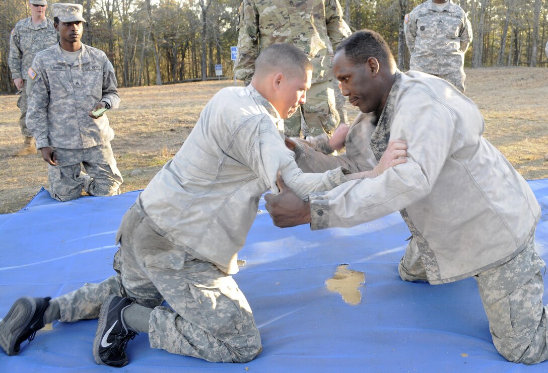 From left, U.S. Army Spc. Kyle K. Meheula of Kalihi, Hawaii, a mechanic with the 642nd Regional Support Group and and Sgt. Lewis Johnson of Elgin, Ill., a squad leader with the 282nd Quartermaster Company, start combatives during the 642nd Regional Support Group's Best Warrior Competition at Fort McClellan, Ala., Feb. 18. (U.S. Army photo by Sgt. 1st Class Gary A. Witte, 642nd Regional Support Group)